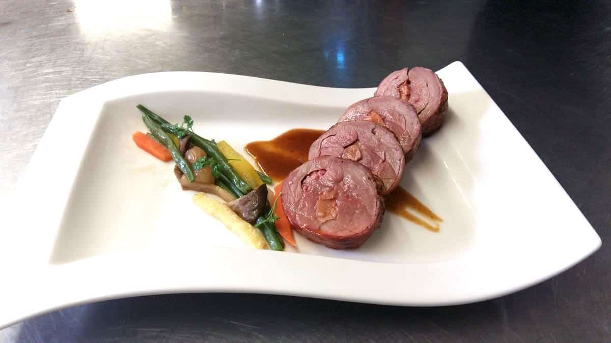 Tournedos of duck breast with foie gras and passion juice, vegetables